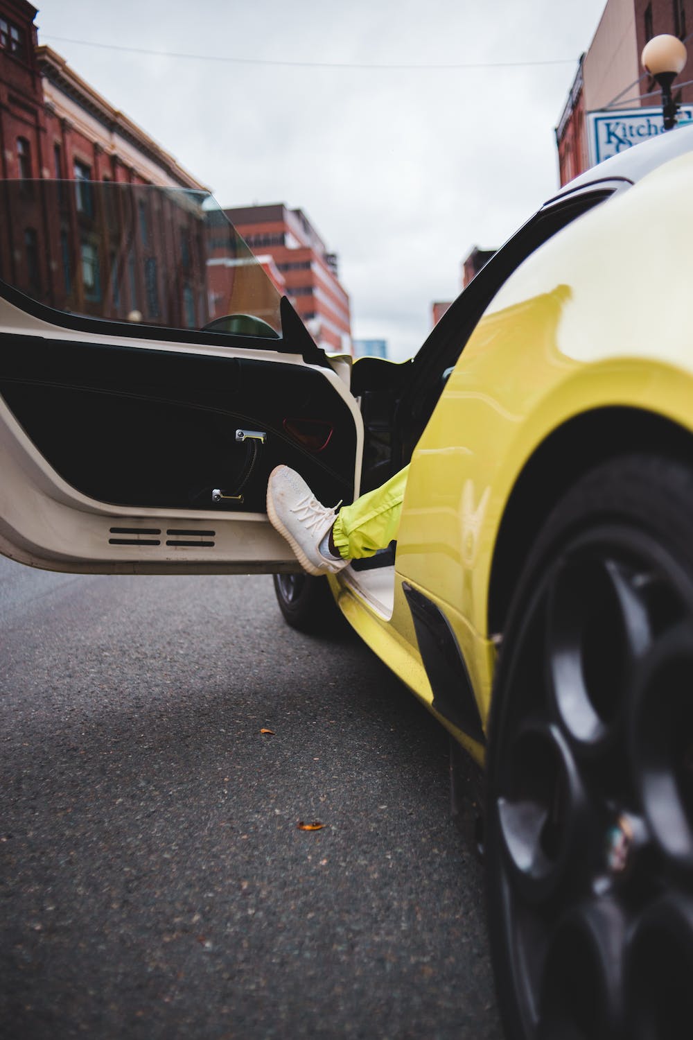 a foot pushing a car door open